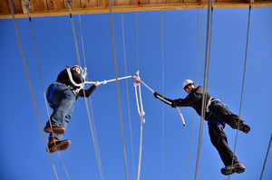 Working in teams, participants have to collectively balance their way across tightropes. 