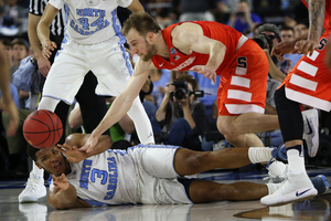 Syracuse's Trevor Cooney and UNC's Kennedy Meeks fight for a loose ball during Saturday's Final Four game.